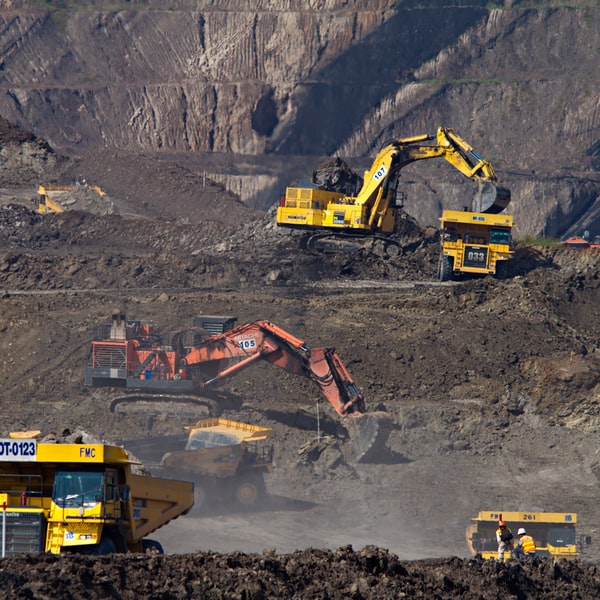 Construction equipment in mining operation with excavators and dump trucks